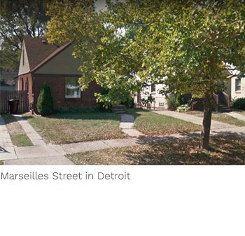 A street view of houses and trees in the city.