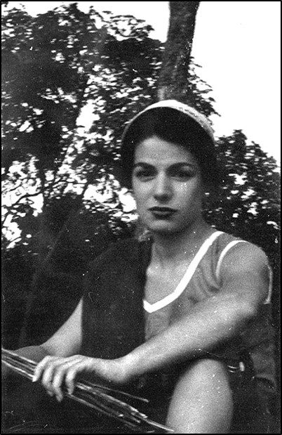 A woman in a white top and headband.