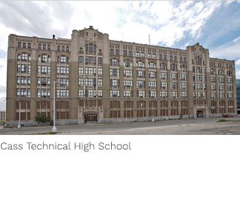 A large building with many windows and a sky background