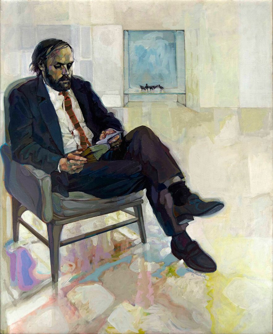 A man sitting in a chair with a book.